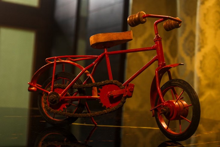 Photo of a red cycle on a reflective surface